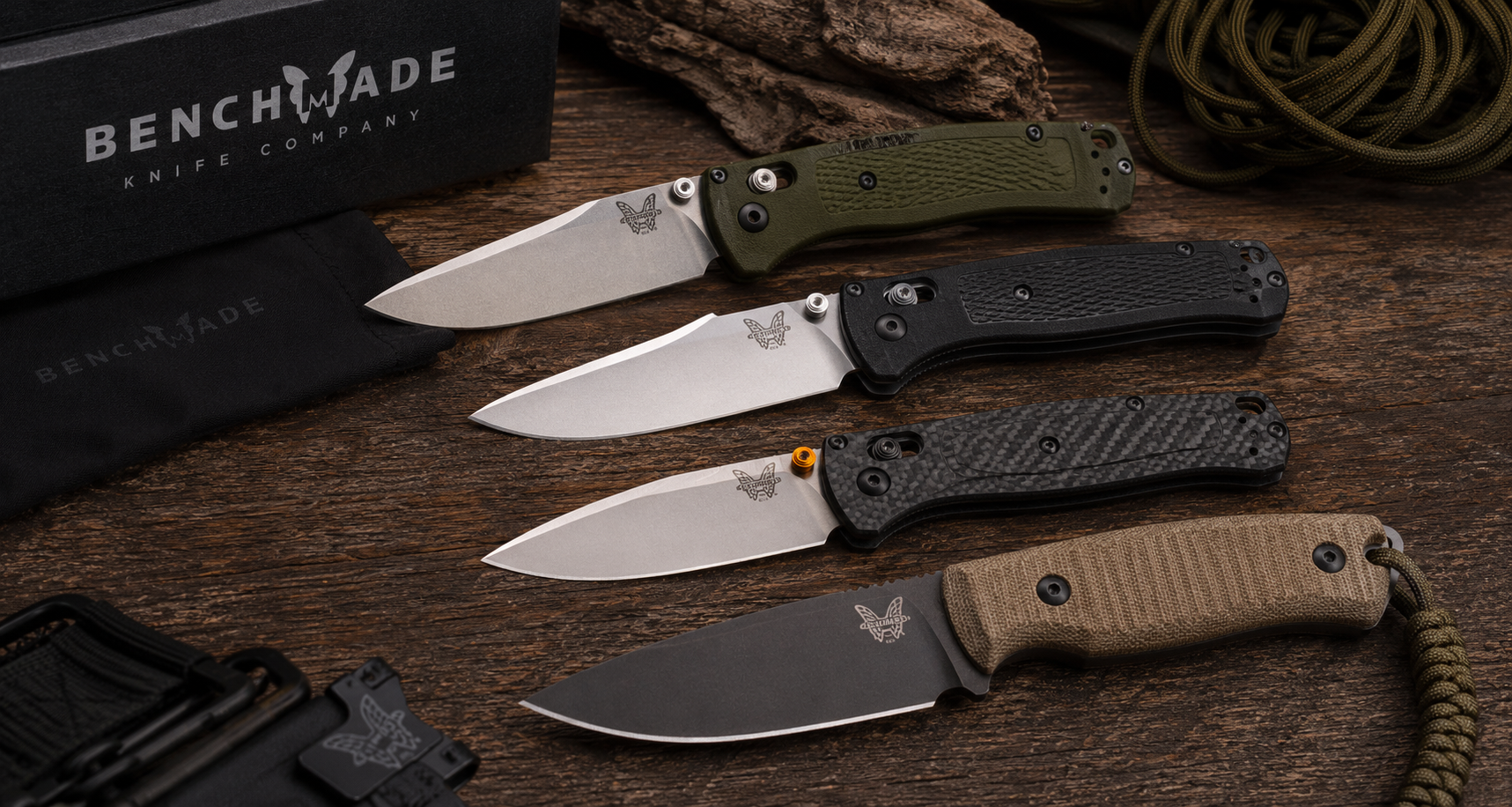 Vintage and modern Benchmade knives displayed on a rustic wood surface with collector accessories.