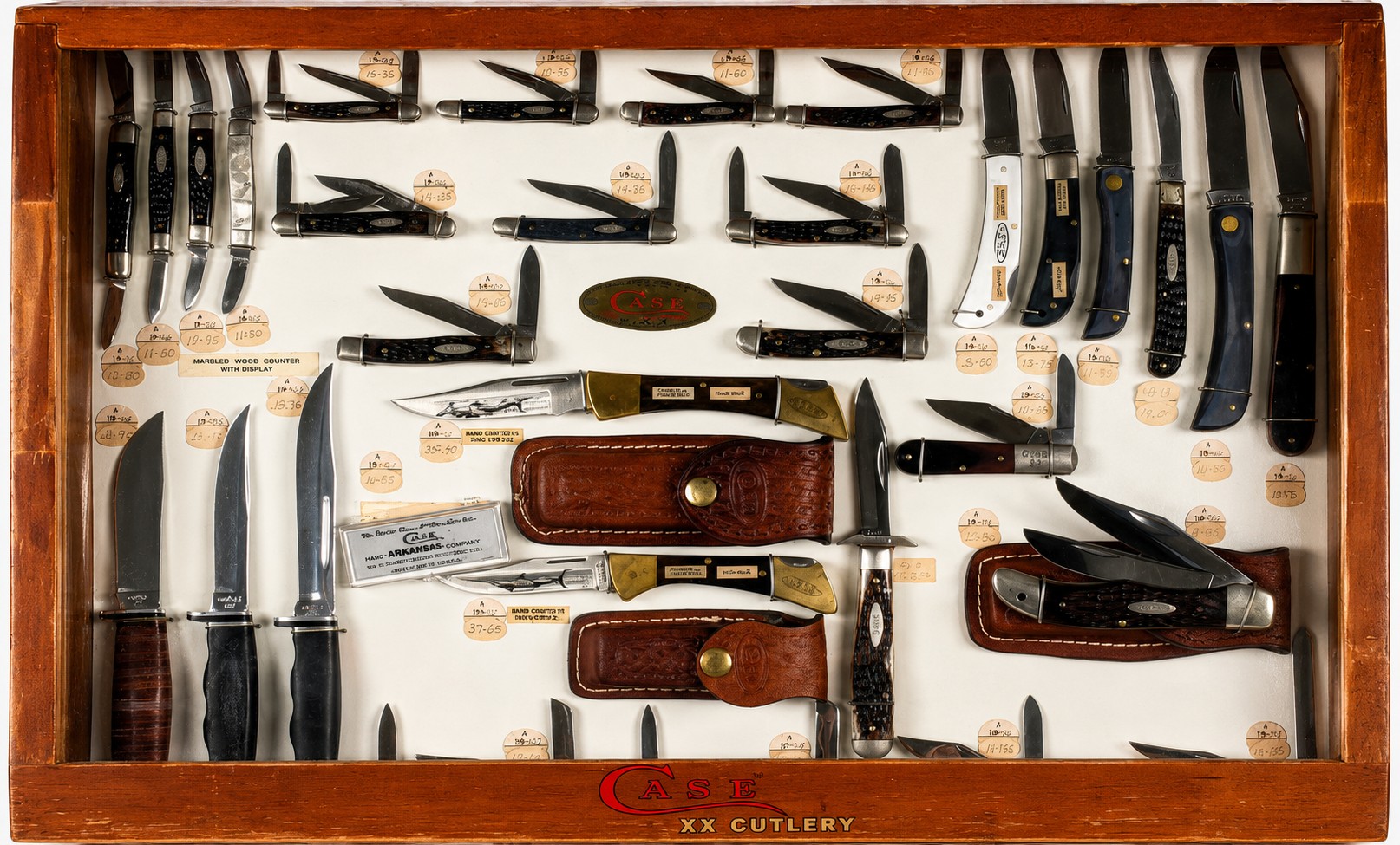 Vintage Case XX pocket knives displayed in a display case.